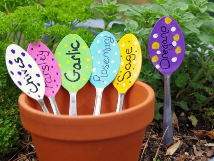 Appiattite dei cucchiaini con un martello e decorateli scrivendo il nome delle piante che avete in giardino