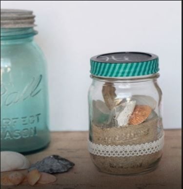 Put sand and some shells in a glass jar.