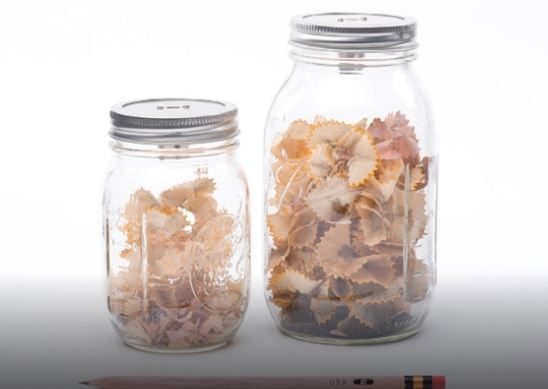 Cut the jar top and insert a pencil sharpener.
