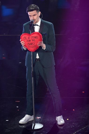 Smoking verde e sneakers bianche per il giovane cantante in gara