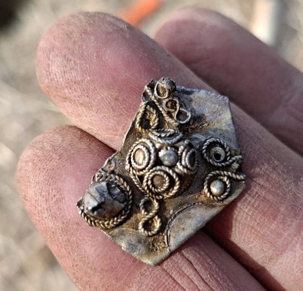 Un frammento di una spilla d'argento, noto come "hack-silver" (argento tagliato), dal tesoro di Mørstad. Nell'epoca vichinga, era il peso dell'argento che contava e i pezzi di argento tagliati potevano essere utilizzati anche come pagamento. Foto: Vegard Sørlie